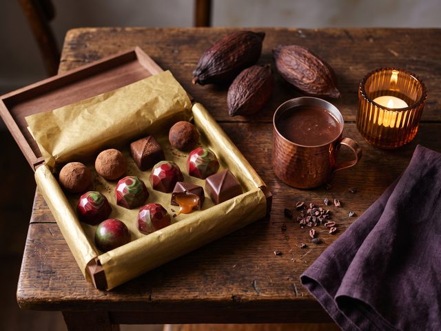 Artisan chocolates in a gold-lined presentation box