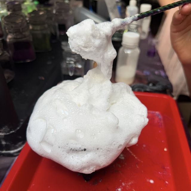 A potion foaming over the top of a cauldron