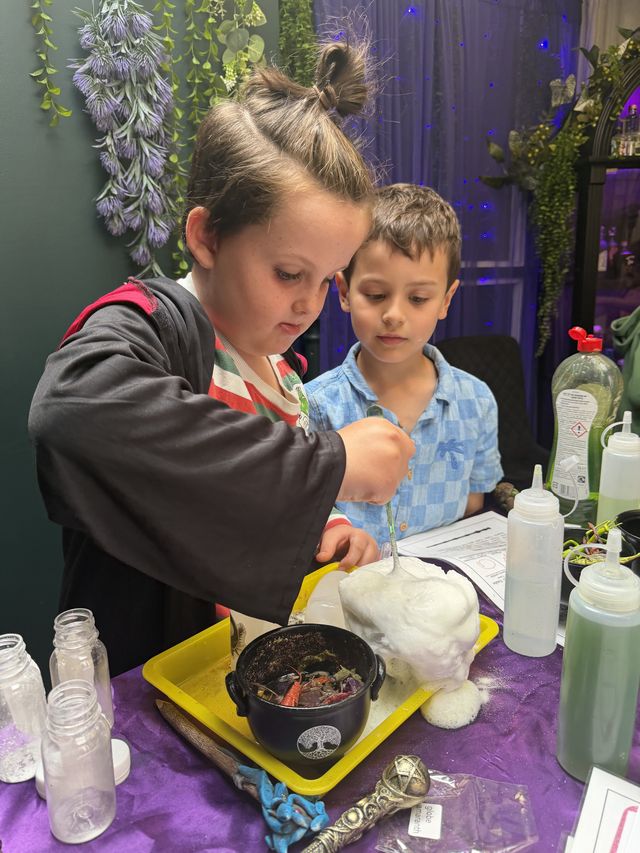 Children watching their potion fizz up
