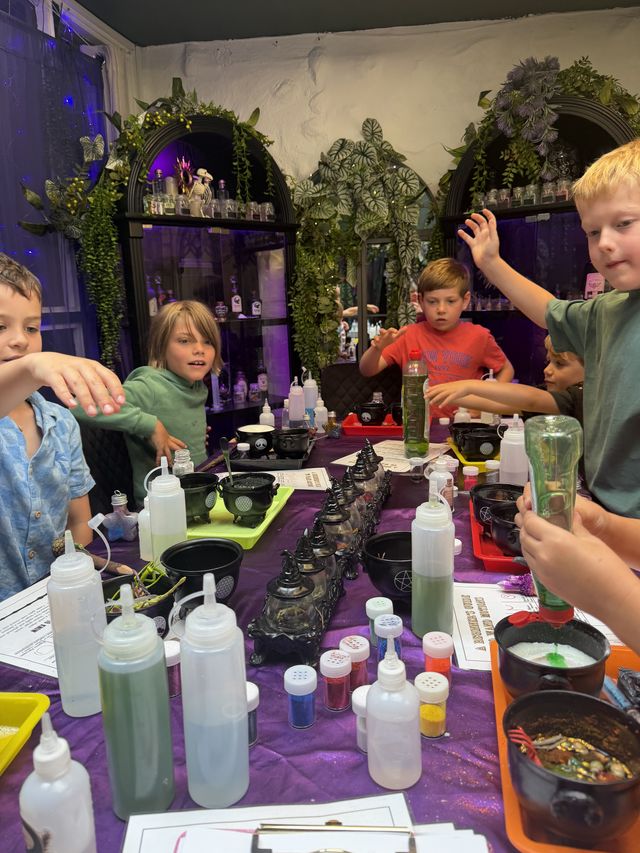 A full table of children brewing