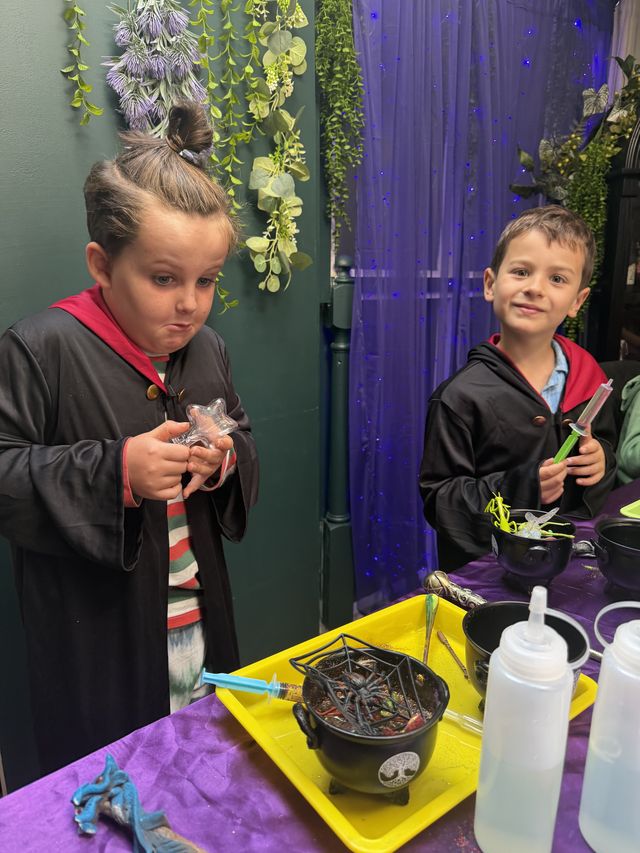 Children in robes picking ingredients with tweezers