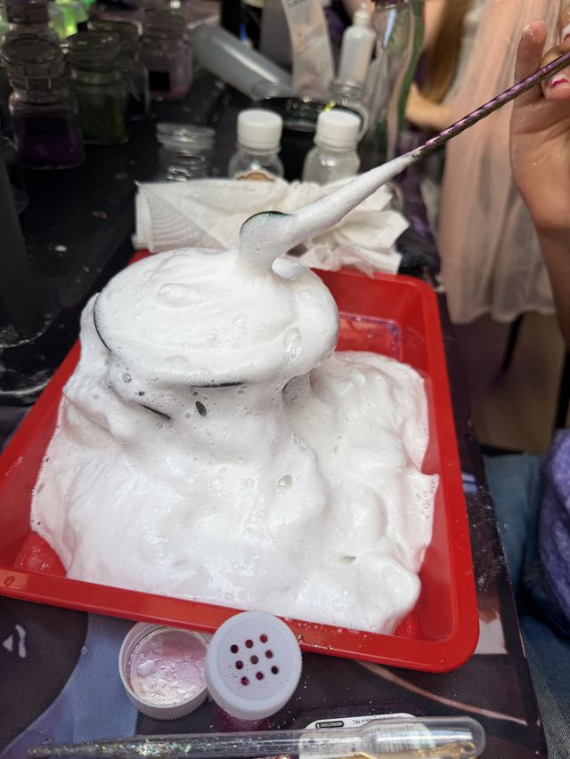 Foam erupting from a cauldron on a red tray