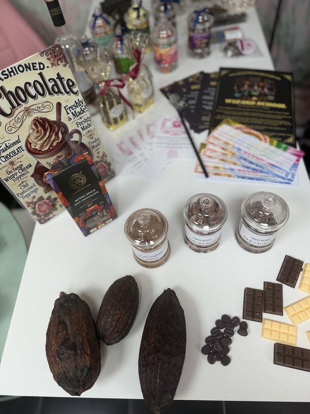 A chocolate tasting table with cocoa pods and bars