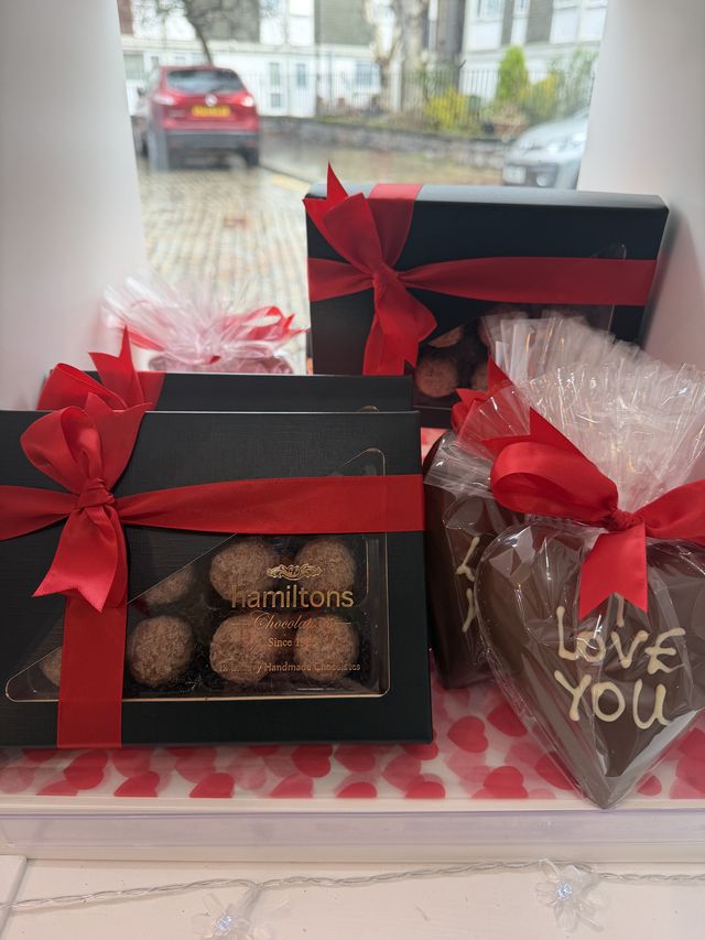 Chocolate gifts and a chocolate heart by the window
